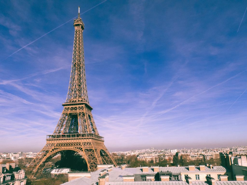 A stunning view of the Eiffel Tower under a bright blue sky in Paris, France.